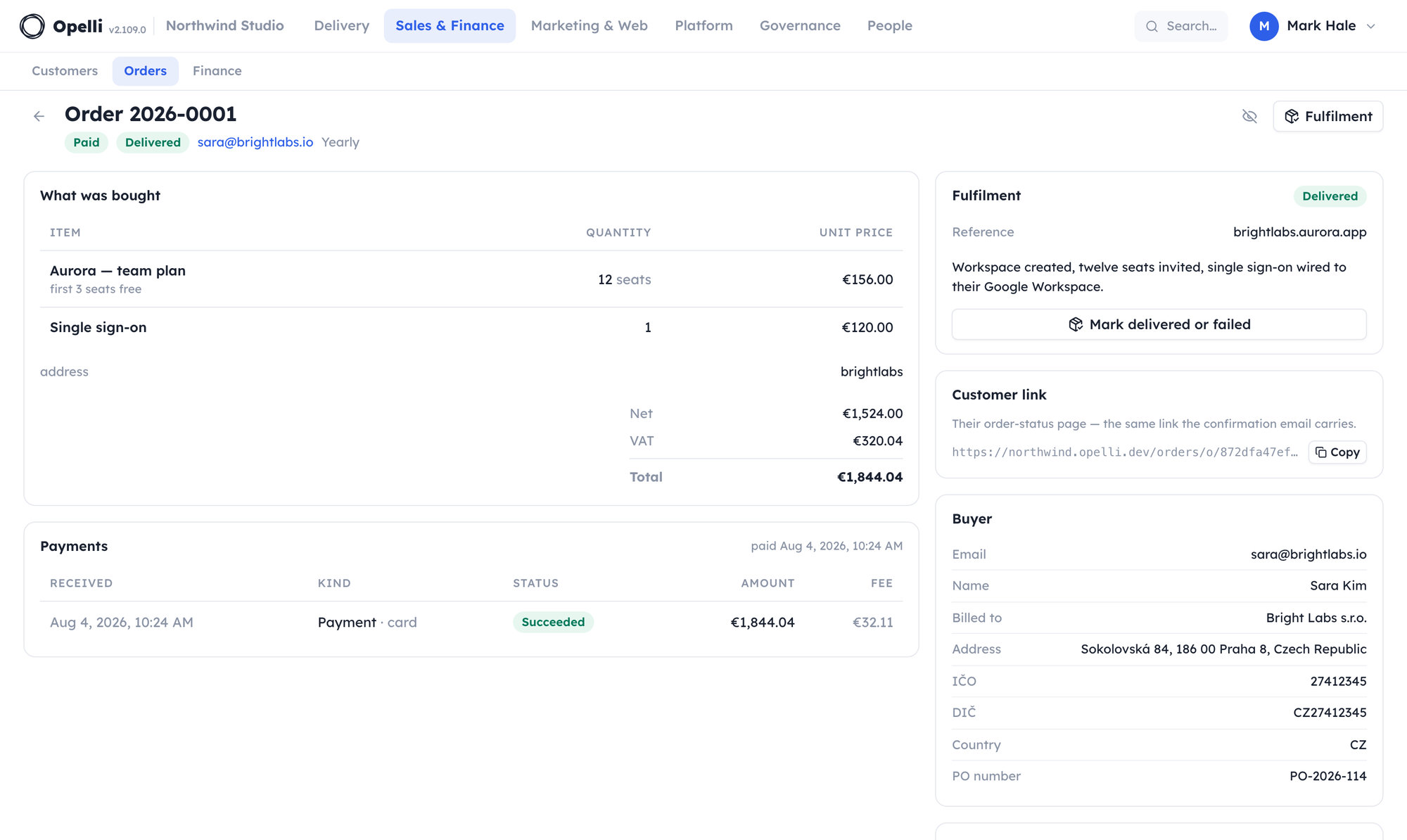 One paid order opened as a page: the lines and frozen totals, the address the buyer chose, the card payment with its fee, and the fulfilment recorded beside the billing details.